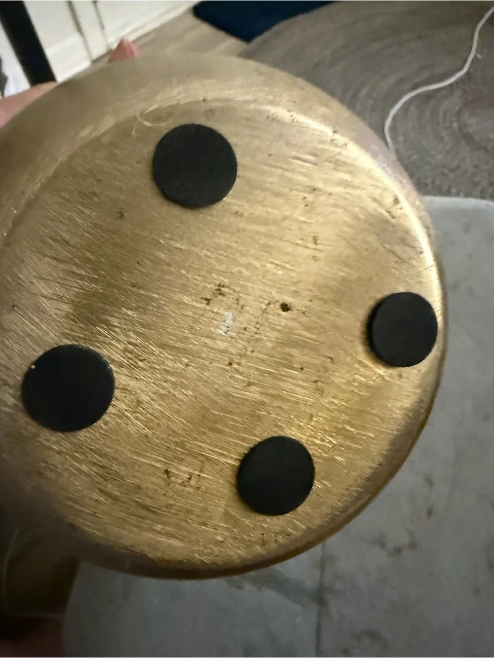 modern, round metal vase or planter with a brushed gold finish.